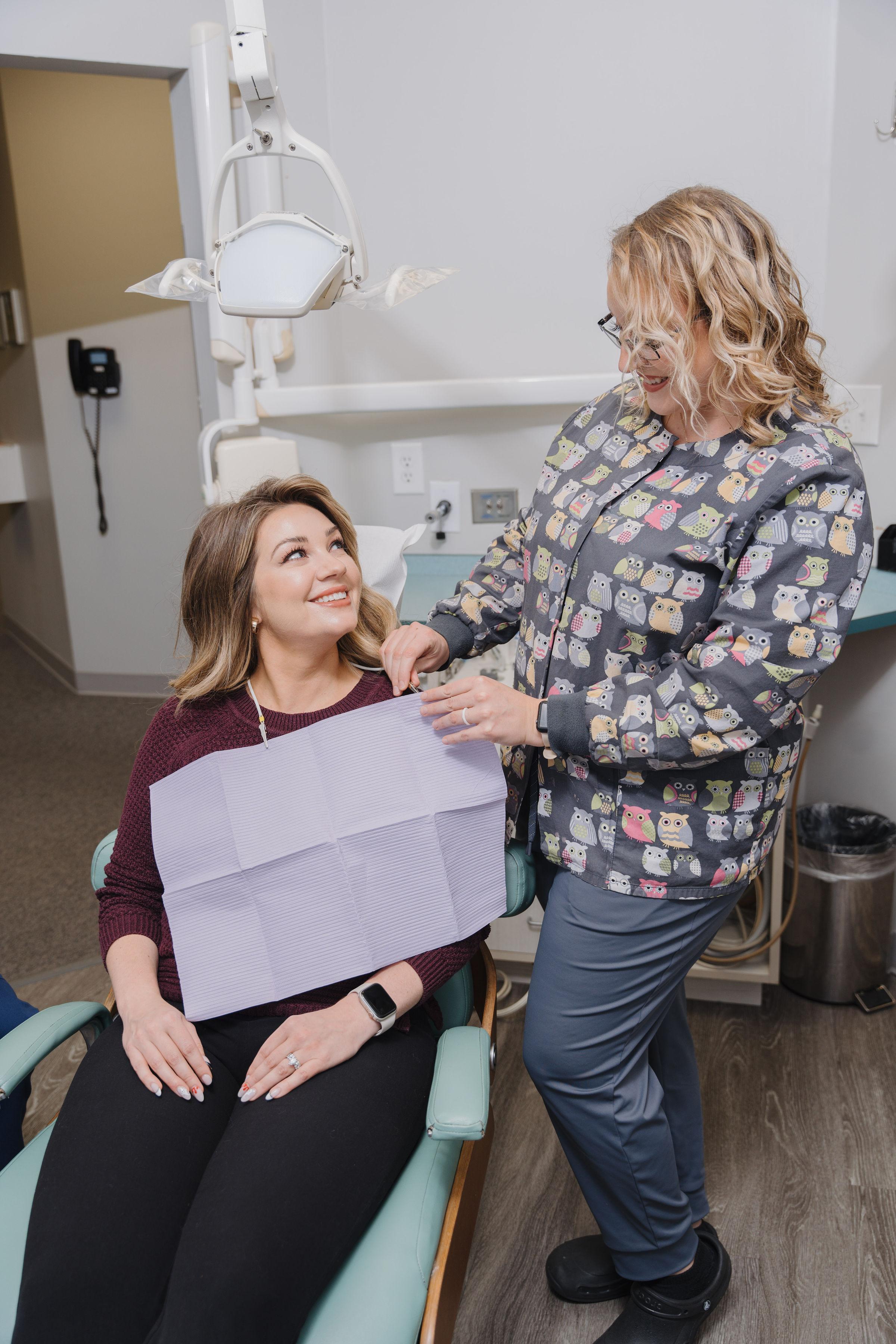 A dentist and dental assistant providing attentive and compassionate care to a dental patient.